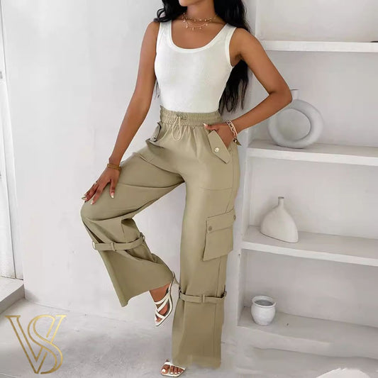 Khaki high-waisted wide-leg cargo pants featuring a drawstring elastic waist, side utility pockets with button flaps, and unique buckle strap details on the lower legs for the vstyles collection.