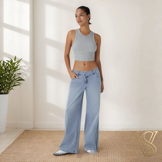 Light wash wide-leg denim with a low-waisted silhouette, paired with a grey ribbed racerback crop top for a minimalist vstyles ready-to-wear aesthetic.