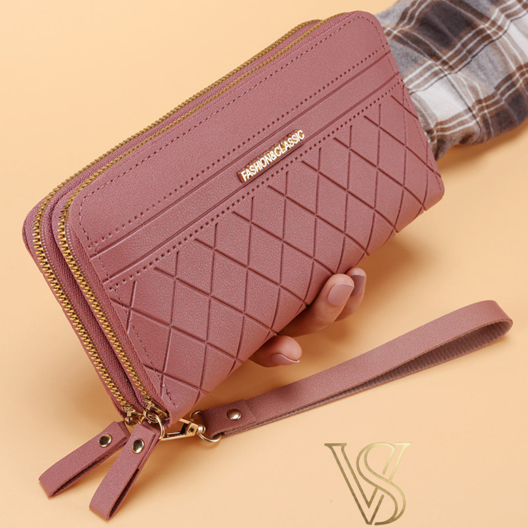 Chic mauve rose long wallet featuring a diamond quilted design, double gold-tone zippers, and a matching wristlet strap.