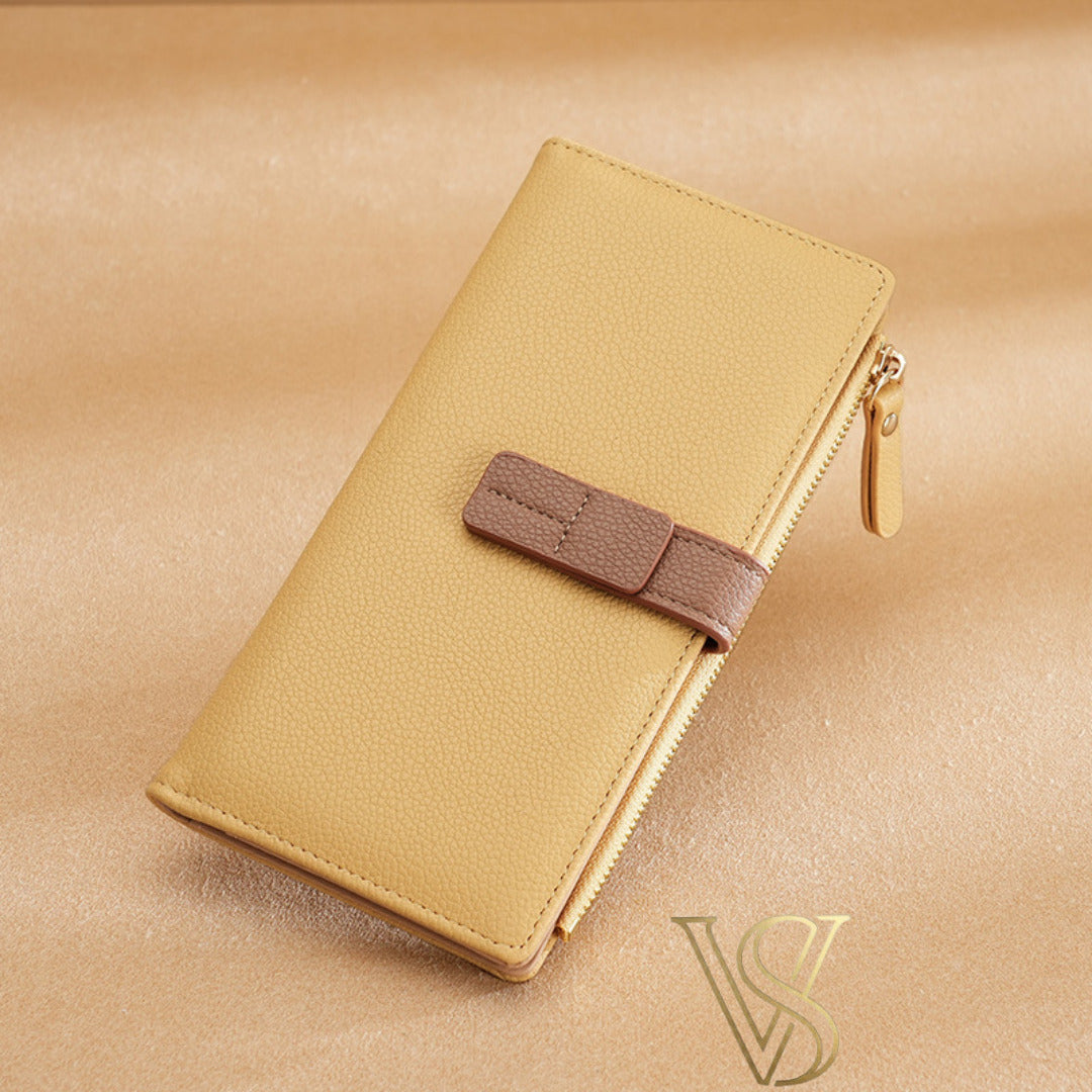 Elegant yellow pebble-grain leather wallet with a brown contrast strap and gold-tone zipper.