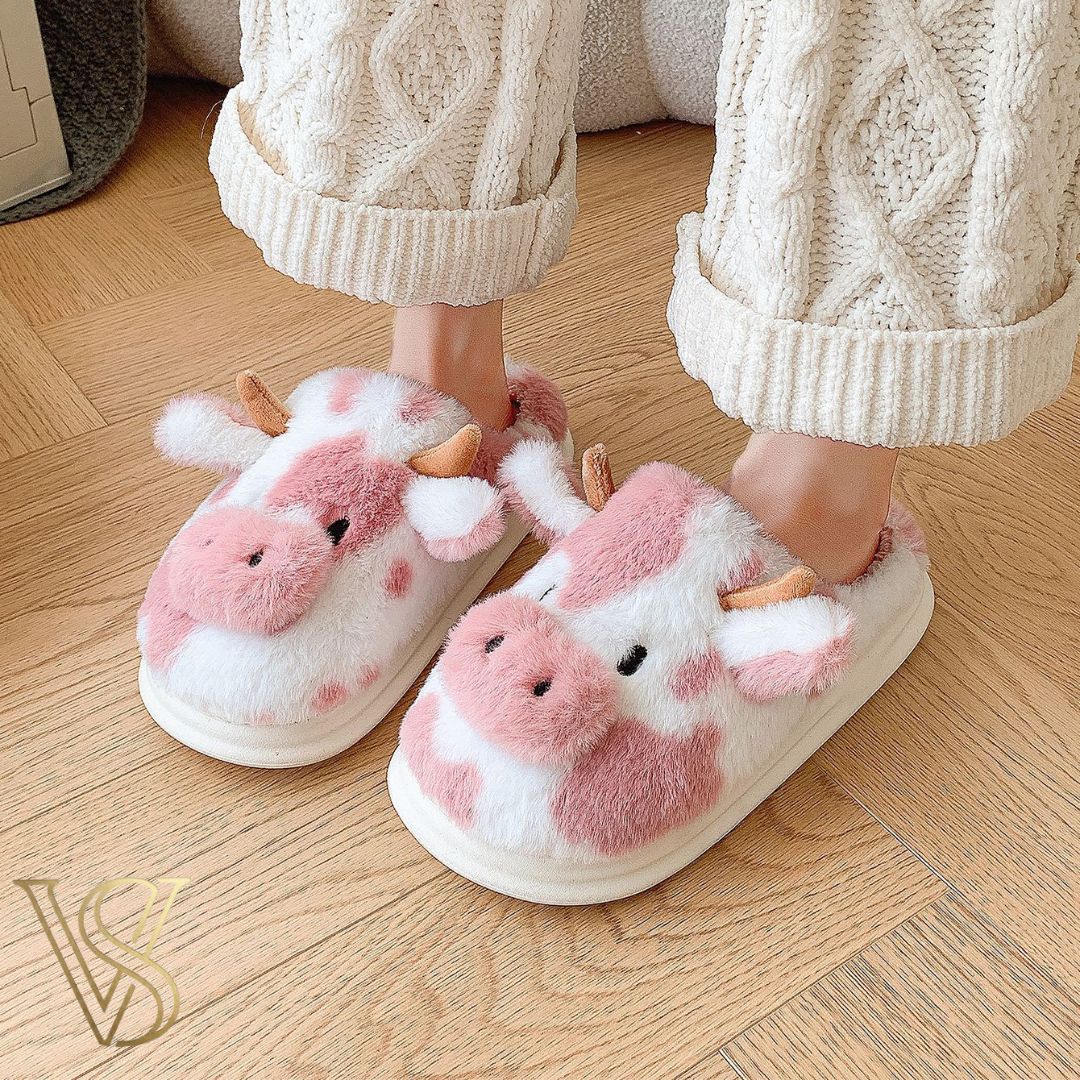Cute pink and white cow-themed plush slippers with horns and ears, featuring a comfortable thick sole for the vstyles lounge collection.