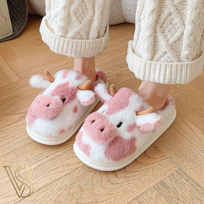 Cute pink and white cow-themed plush slippers with horns and ears, featuring a comfortable thick sole for the vstyles lounge collection.