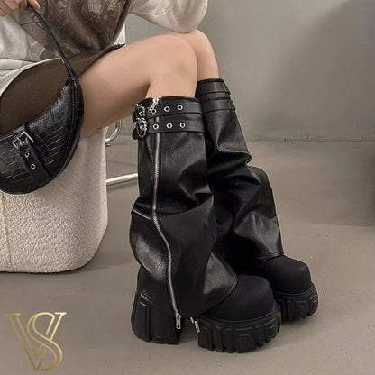 Black industrial platform boots with chunky high heel, metallic zipper hardware, and adjustable buckle straps.