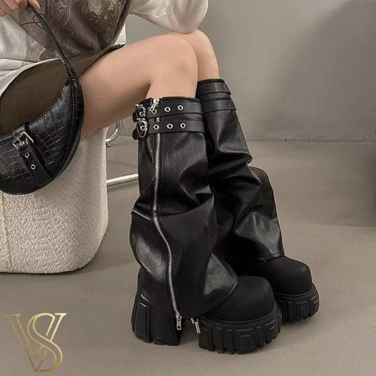 Black industrial platform boots with chunky high heel, metallic zipper hardware, and adjustable buckle straps.