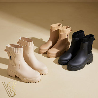 Women's chunky lug sole ankle boots featuring a matte waterproof finish and a comfortable ribbed knit sock collar, shown in cream, beige, and black.