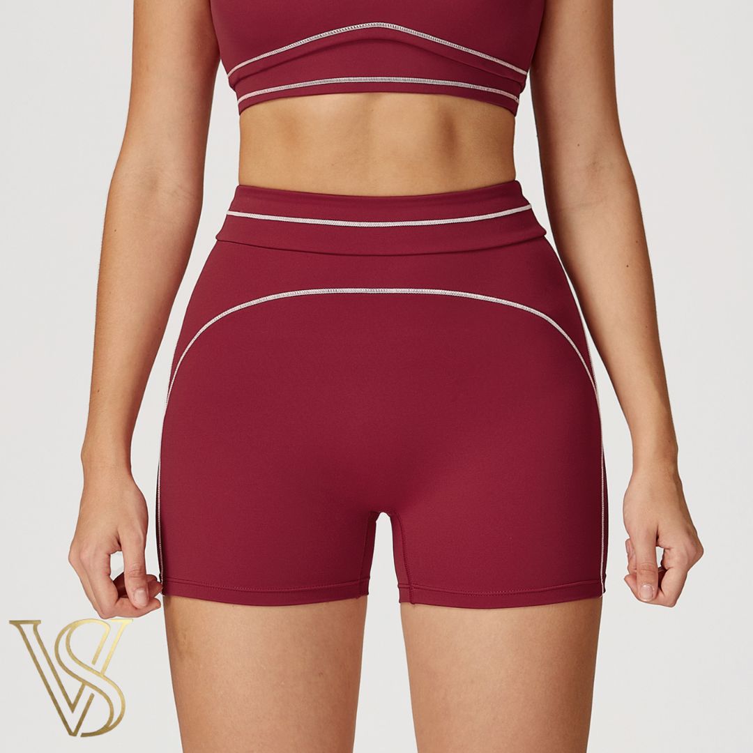 Burgundy high-waisted workout shorts with white piping accents and matching top, part of the vstyles activewear collection.