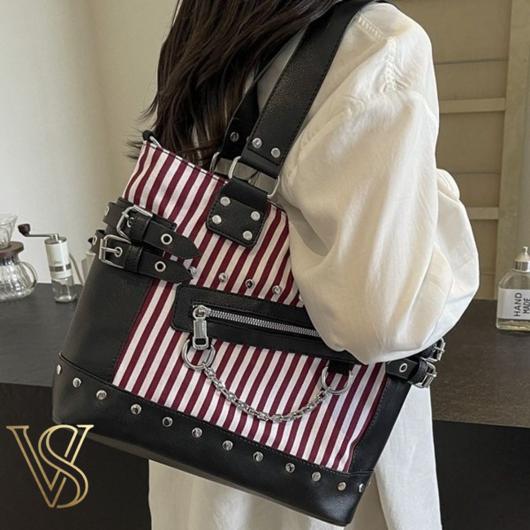 Bold red and white striped punk tote bag with silver stud accents, side buckle hardware, and a decorative silver chain.