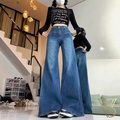 High-waisted medium blue wide-leg jeans with decorative front pocket stitching and a relaxed silhouette, styled with a black long-sleeve crop top for the vstyles collection.