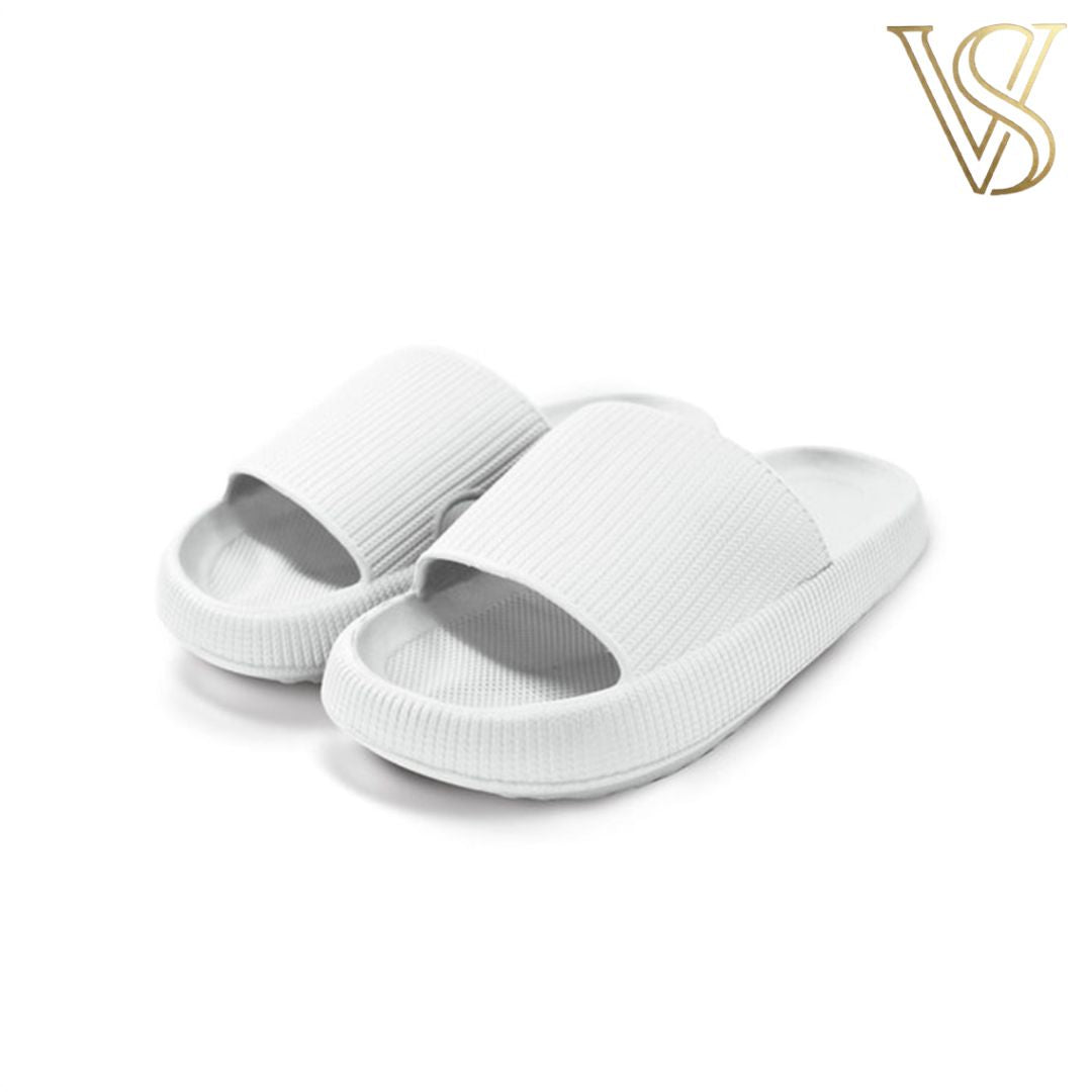 Minimalist white seamless cloud slides with a thick platform sole and textured strap, perfect for indoor and outdoor wear by vstyles.