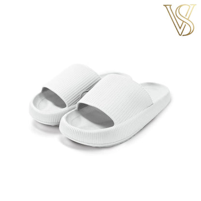 Minimalist white seamless cloud slides with a thick platform sole and textured strap, perfect for indoor and outdoor wear by vstyles.