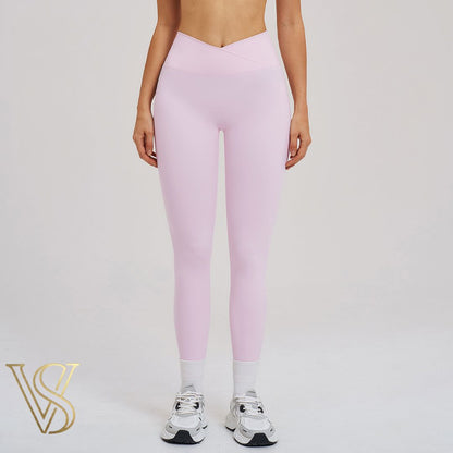 Soft light pink crossover leggings with a high-waisted V-cut waistband and full-length design for the vstyles collection.