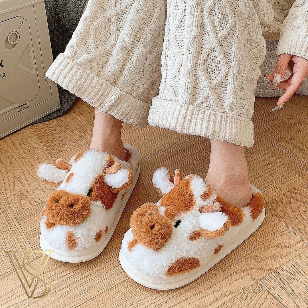 Adorable brown and white cow-themed plush slippers with a soft fleece lining and thick white sole, part of the vstyles footwear line.