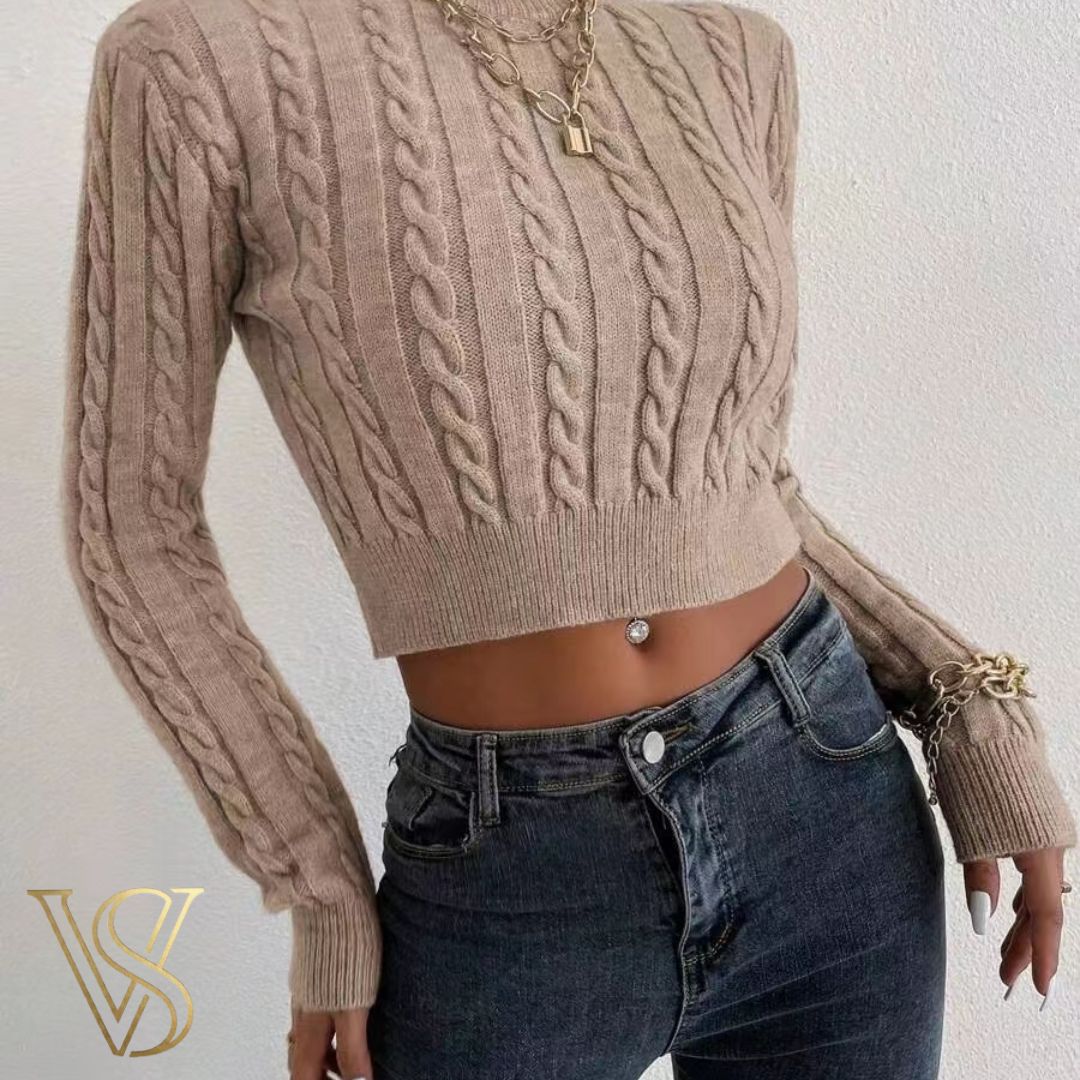 Chic light tan cropped cable-knit sweater with a crew neckline and fitted long sleeves, styled with dark-wash jeans and gold chain jewelry for the vstyles collection.