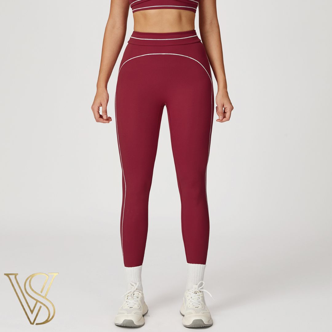 Burgundy high-waisted seamless leggings featuring white contrast stitching and a supportive double-banded waistband by vstyles.