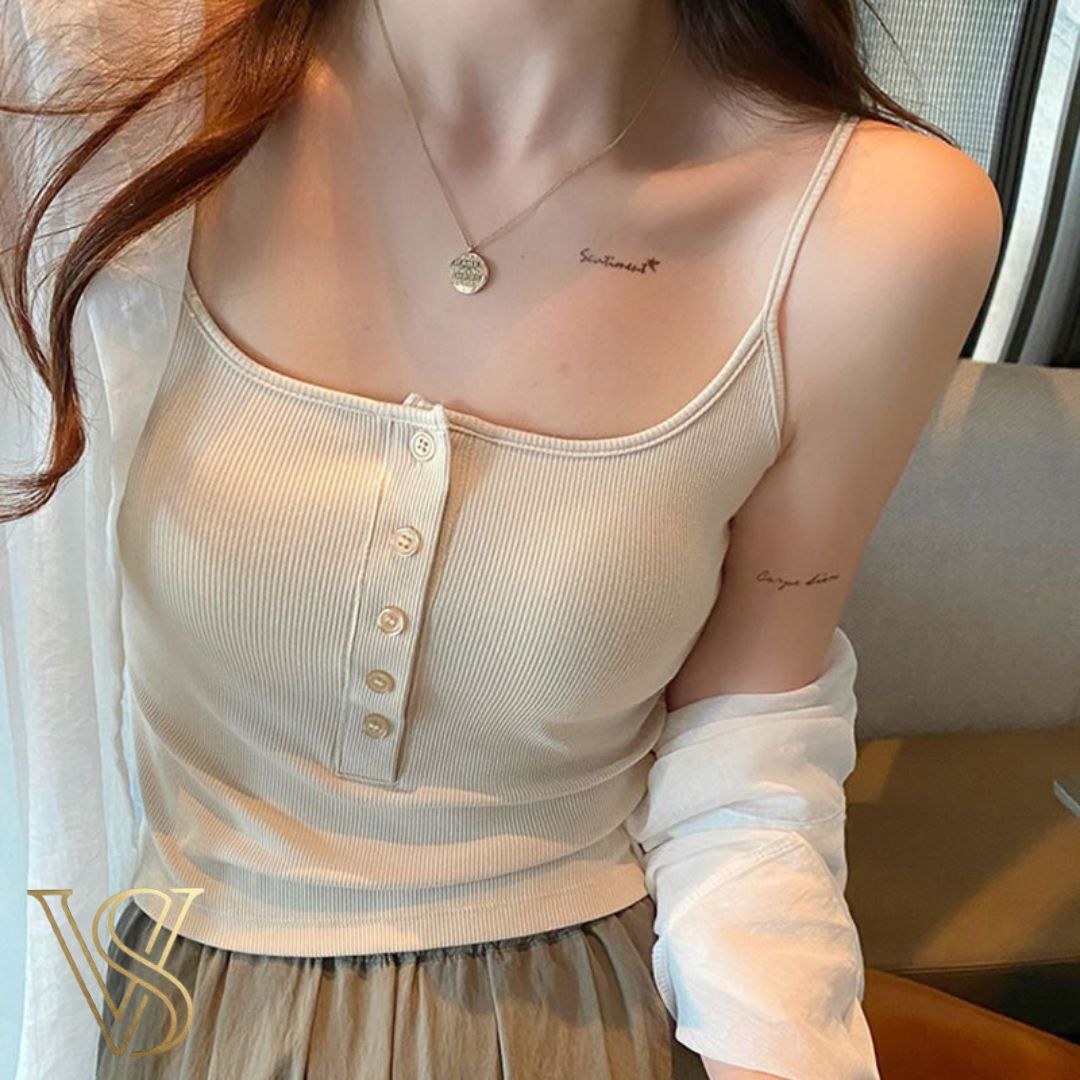 Soft cream-colored ribbed henley camisole with a button-front detail and delicate straps, ideal for a minimalist vstyles look.