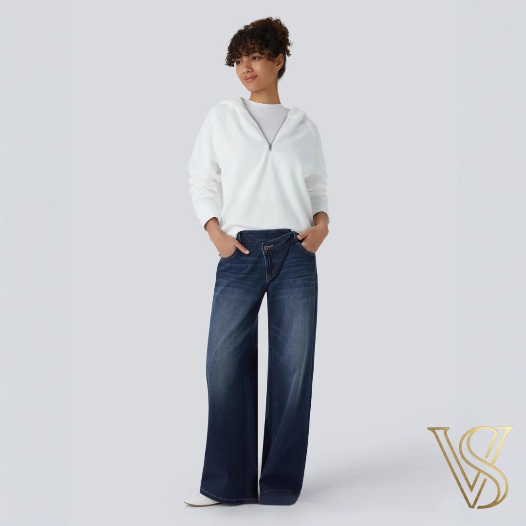 Deep indigo wide-leg jeans featuring a low-rise waistband, effortlessly styled with a white quarter-zip hoodie for the vstyles collection.