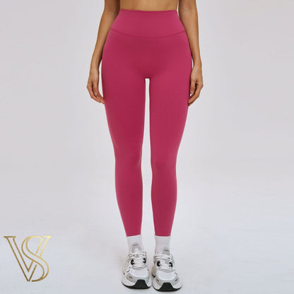 Vibrant magenta high-waisted seamless leggings, offering a contoured fit and breathable performance fabric for active lifestyles at vstyles.