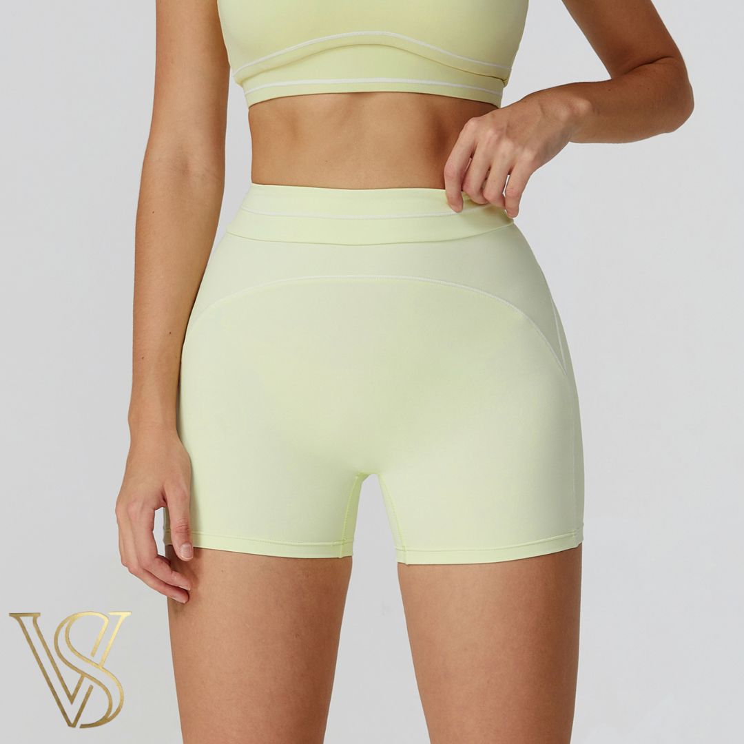 Light yellow high-waisted seamless athletic shorts with white stitch detailing, from the vstyles ready-to-wear line.