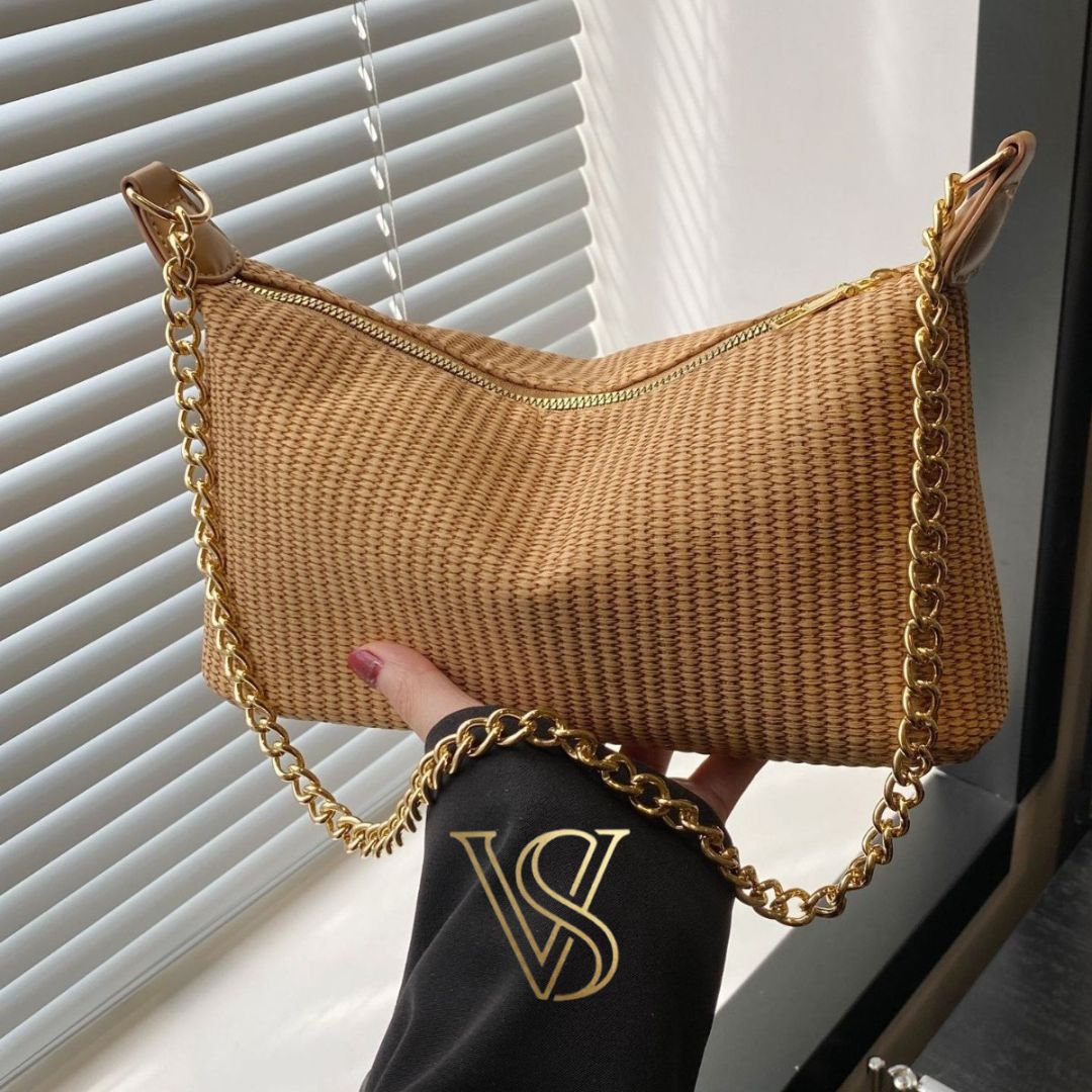 Khaki tan woven straw handbag with a gold chain shoulder strap and minimalist design.