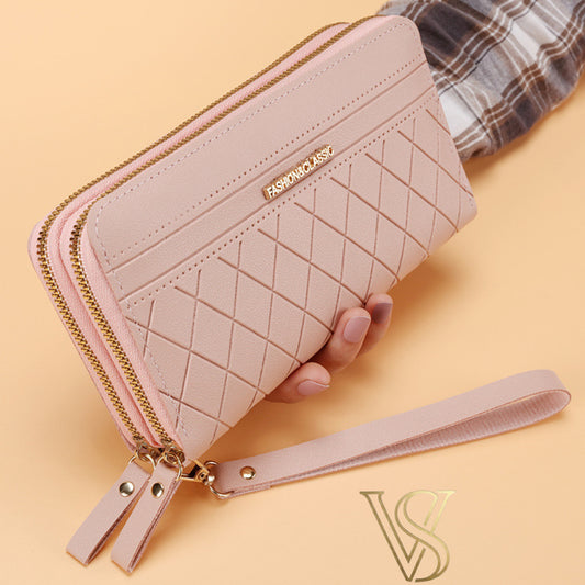 Soft blush pink long wallet with a diamond quilted texture, double gold-tone zippers, and a matching wristlet strap.