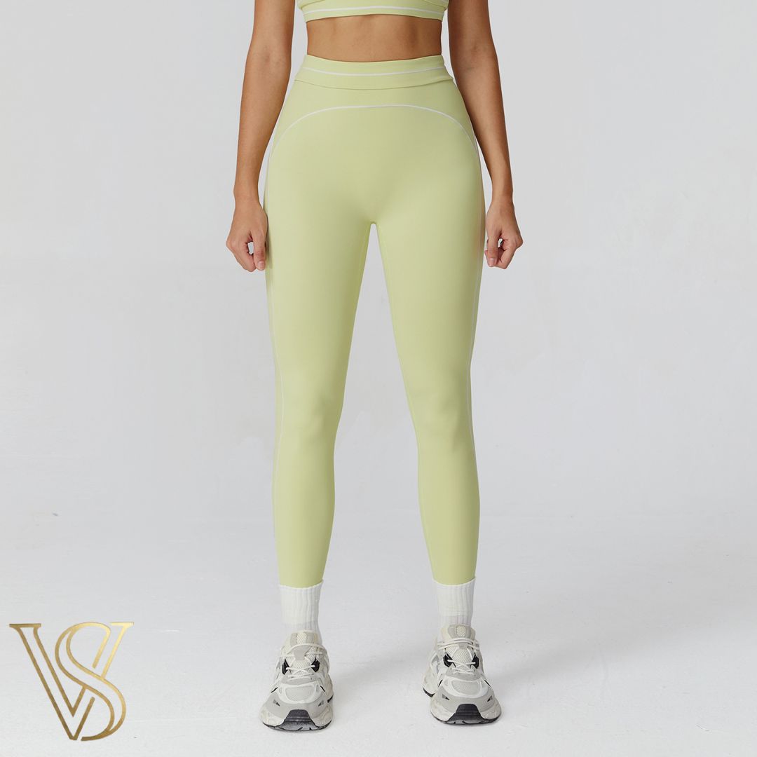 Light yellow high-waisted seamless leggings with white contrast stitching and a double-banded waist, part of the vstyles ready-to-wear line.