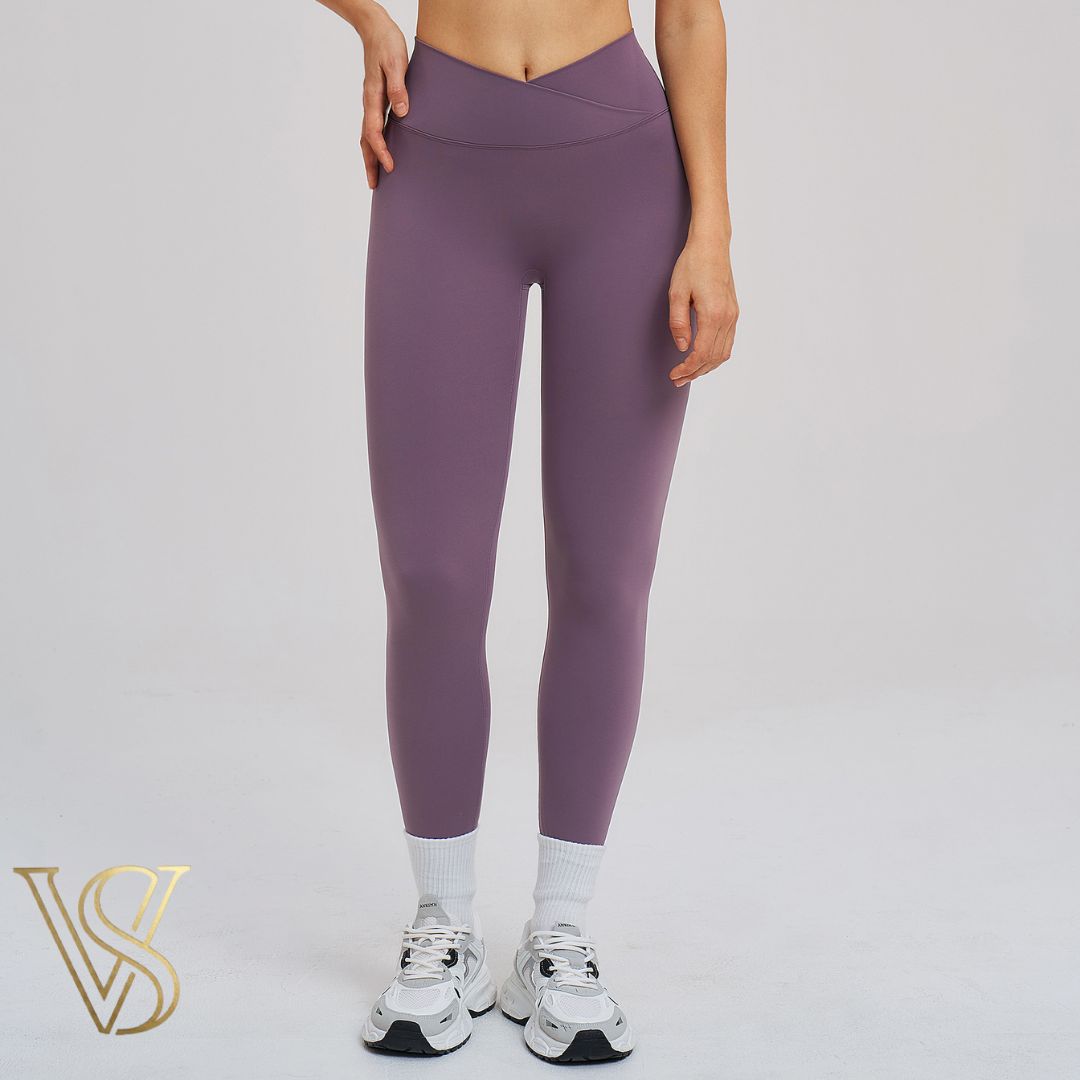Dusty purple high-waisted crossover leggings featuring a V-shaped waistband and seamless full-length fit at vstyles.