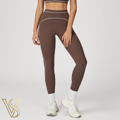 Dark brown high-waisted seamless leggings featuring white contrast stitching and a double-banded waistband, branded by vstyles.