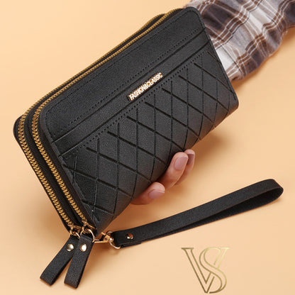 Elegant black long wallet with a diamond quilted pattern, double gold-tone zippers, and a matching wristlet strap.
