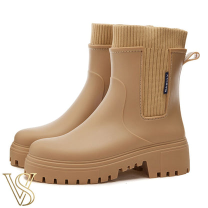 Tan beige waterproof ankle boot with a chunky lug sole and matching ribbed knit sock-style collar.