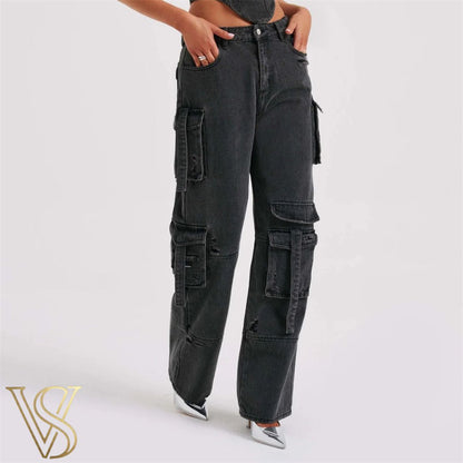 Washed black high-waisted denim cargo jeans with functional multi-pocket styling, strap details, and a relaxed silhouette, branded for the vstyles ready-to-wear line.