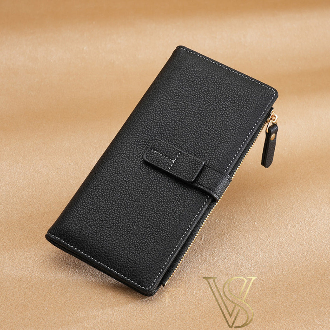 Classic black pebble-leather long wallet with white contrast stitching and a matching black strap.