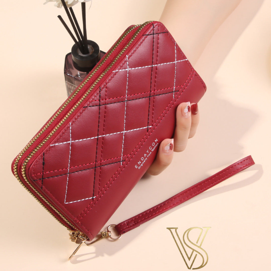 Deep red diamond-stitched long wallet with double gold-tone zippers and matching wristlet.