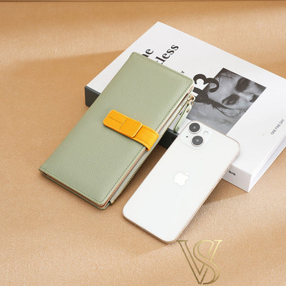 Sage green pebble-leather wallet with a vibrant yellow contrast strap and gold hardware.